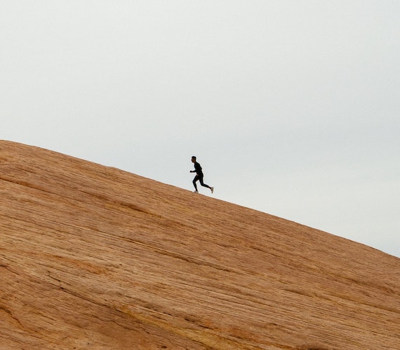 A person jogging uphill.