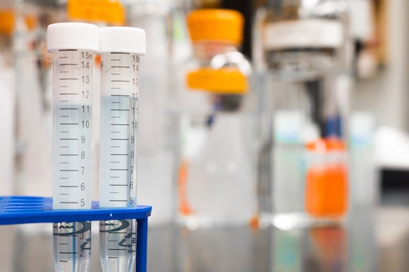 Two vials in a test tube holder.