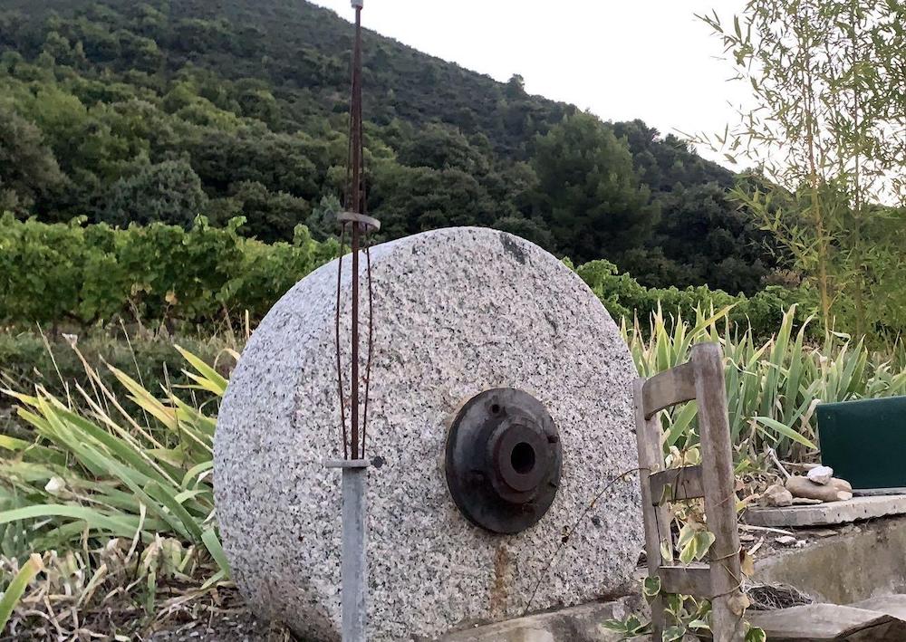 A grinding stone traditionally used to crush olives.