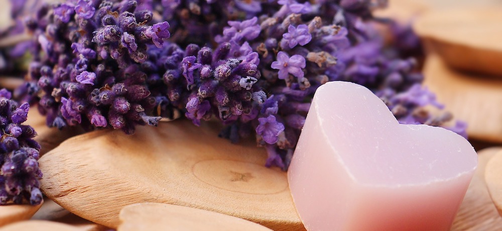 A heart-shaped butter next to a collection of lavender buds.